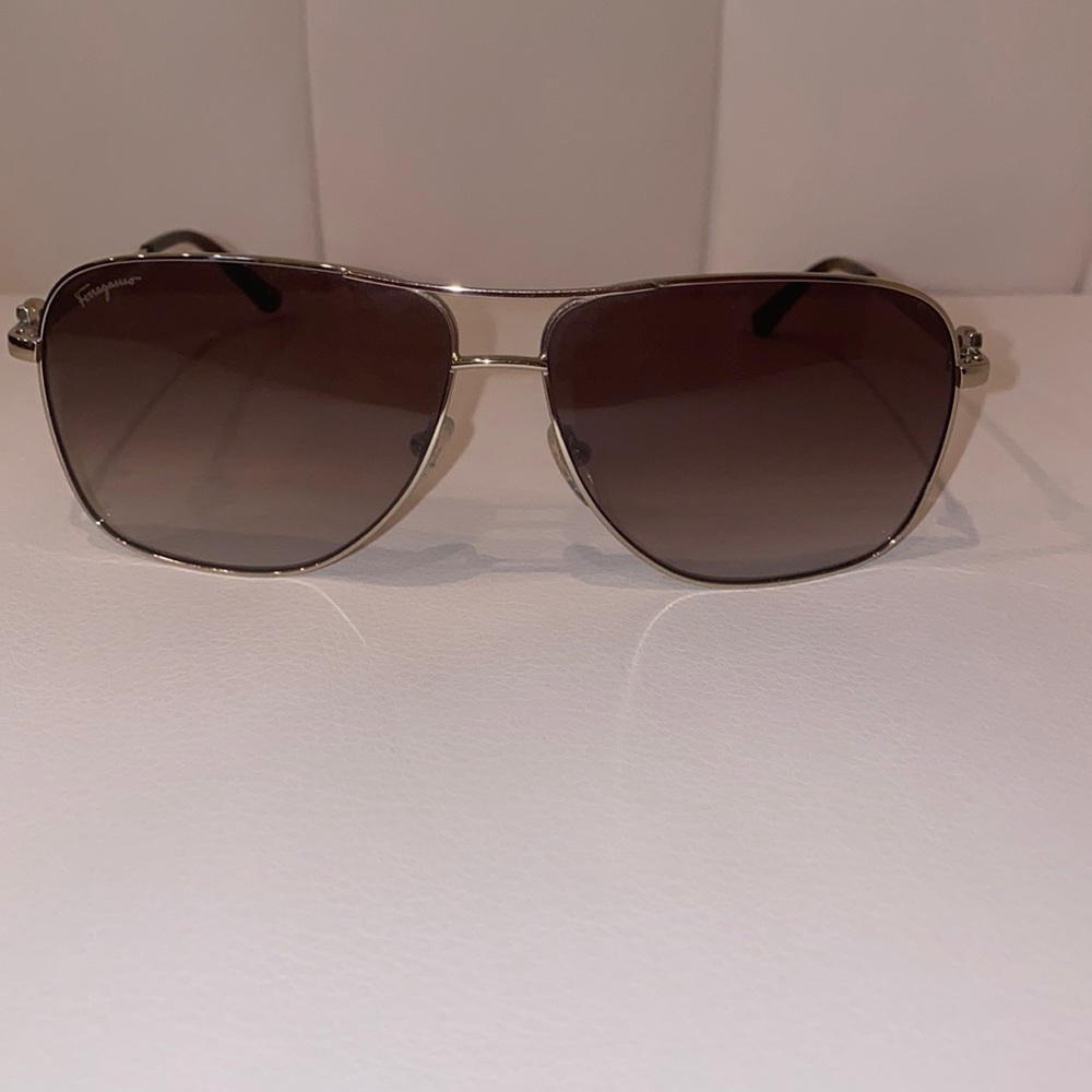 Salvatore Ferragamo.  Lightly Used still in good condition.  Color - Gold